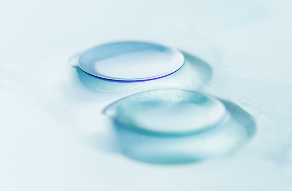 A close up of two contact lenses sitting on a surface