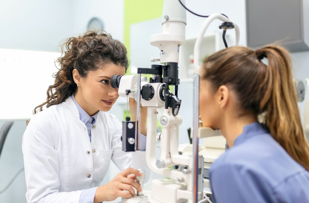 An eye doctor assessing and patient's eyes during a comprehensive eye exams to determine the cause of the patient's eye redness