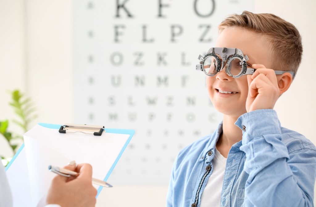 Young boy sitting in an eye clinic taking a visual acuity test to check for nearsightedness