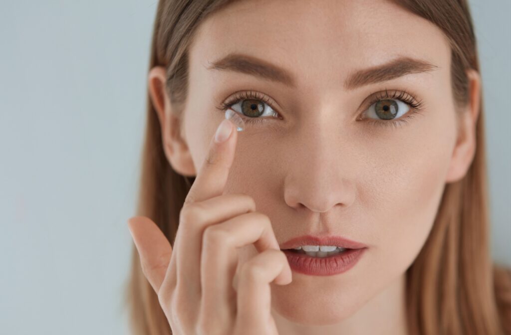 A young individual applying their contact lens.