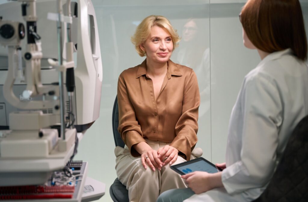 A senior person discussing eye care with an optometrist during an eye exam