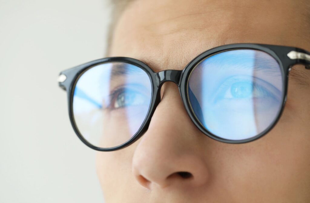 A close up of glasses that are showing a reflection in the lens